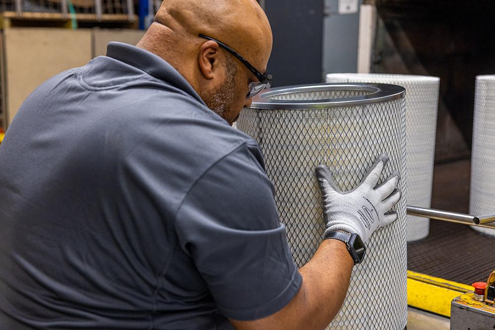 Professional technician inspecting Fleetguard filter - ProFleet Filtration quality assurance